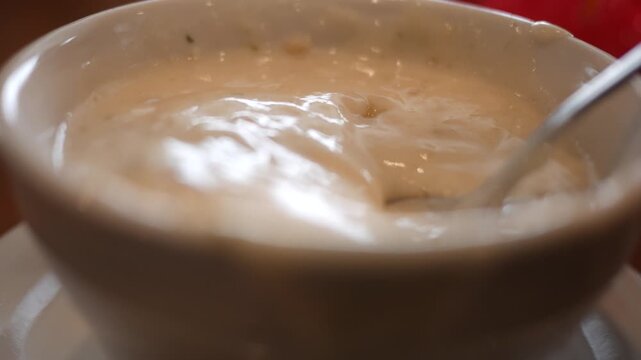 Spoon Scoops Clam Chowder or Potato Soup in Cup