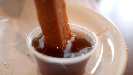 Waffle or French Toast Stick Being Dipped in Syrup