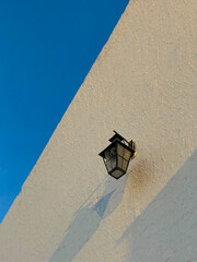 Old lamp on a white wall 
