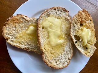 Slices of buttered ciabatta toast on a plate