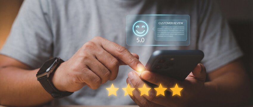 Man using mobile phone to leave excellent five star rating and positive feedback on virtual screen