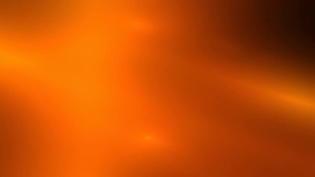 Intense, warm orange abstract light flares softly transition across a blurred digital background, creating a vibrant, energetic texture.