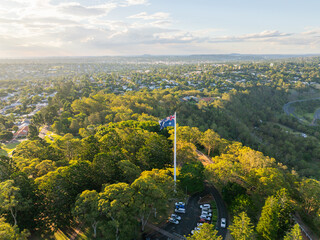 Scenic elevated views of the Australia flag on display at the Picnic Point public park area in Toowoomba with Table Top Mountain and the Bushland Reserve in the background, Queensland, Australia