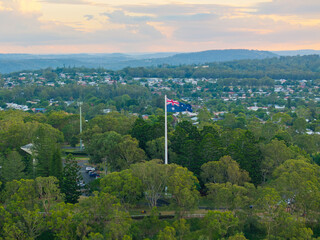 Scenic elevated views of the Australia flag on display at the Picnic Point public park area in Toowoomba with Table Top Mountain and the Bushland Reserve in the background, Queensland, Australia