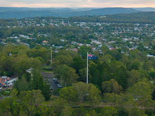 Scenic elevated views of the Australia flag on display at the Picnic Point public park area in Toowoomba with Table Top Mountain and the Bushland Reserve in the background, Queensland, Australia