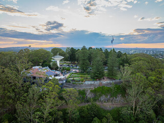 Scenic elevated views of the Australia flag on display at the Picnic Point public park area in Toowoomba with Table Top Mountain and the Bushland Reserve in the background, Queensland, Australia