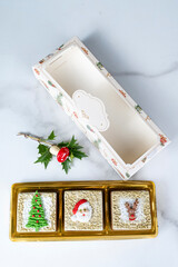 Brazilian honey cakes lined up and decorated with marzipan in a Christmas theme_vertical.