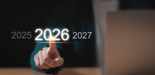 Touch the digital interface with your finger. Select the year 2026 from 2025 and 2027.