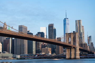 Naklejka premium Brooklyn bridge to Manhattan on sunset. Urban architecture of New York city. Brooklyn bridge of New York city. Brooklyn landmark. Manhattan cityscape with skyscraper architecture