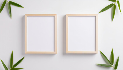 Wooden Picture Frame with Green Leaves on Textured Wall and copy space.