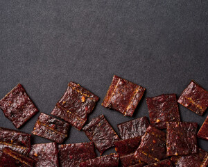 flat lay jerky pork on black background with copy space