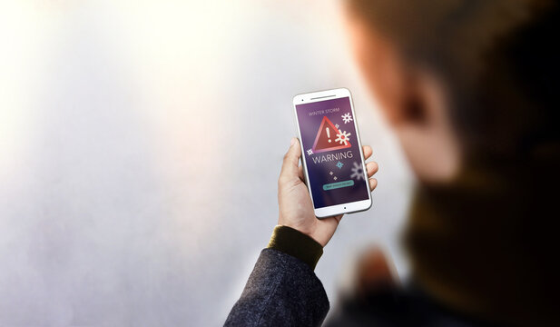 Winter Storm Warning Alert on Mobile Phone Smartphone, Climate change