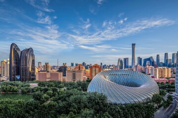 A stunning view of the Beijing Phoenix Center and CBD skyline, showcasing modern architecture with lush green surroundings under a vibrant sky. © VisualCoordinates