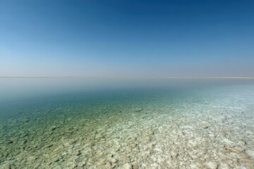 Tranquil Coastal Landscape With Calm Water And Pebbles