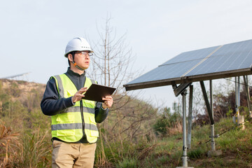 asian engineer working in solar power station with digital tablet