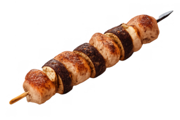 Grilled chicken pieces alternating with zucchini slices on a skewer, cooking fresh meat and vegetables for a healthy meal