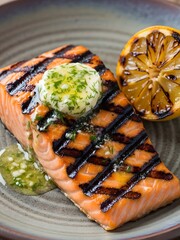 Grilled salmon steak with herb butter and lemon
