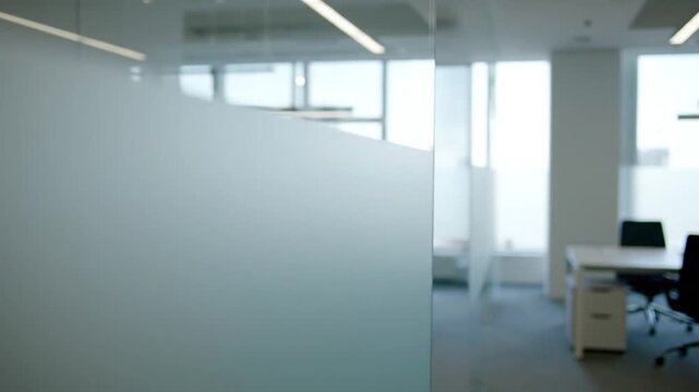 Modern office space with frosted glass partition and natural light