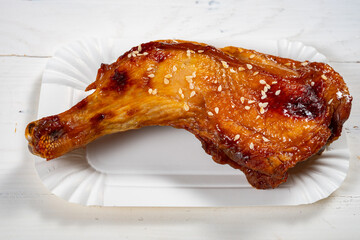 angle view honey-glazed roasted chicken drumstick at horizontal composition