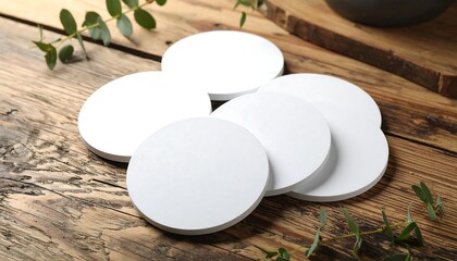 Blank White Circular Coasters on Rustic Wooden Table.