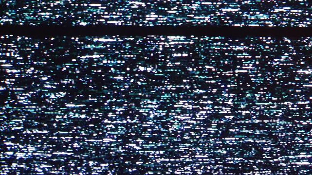 Close-up view of television screen static, displaying a chaotic pattern of white, grey, and black pixels, indicating signal interference or an absent broadcast.