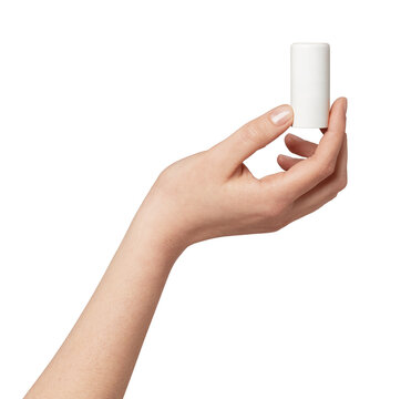 Female hand holding a minimalist white cylindrical cosmetic stick against a neutral studio background, clean unbranded packaging for skincare, deodorant, or balm mock-up and display