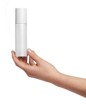 Person's hand holding up a white unbranded cosmetic spray bottle, perfect for showcasing product branding, beauty, hygiene, skincare, and personal care concepts