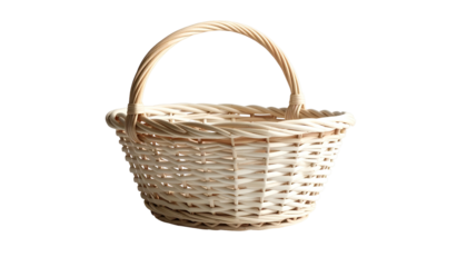 A close-up shot of a small, woven wicker basket with a rounded handle, isolated on a stark black background