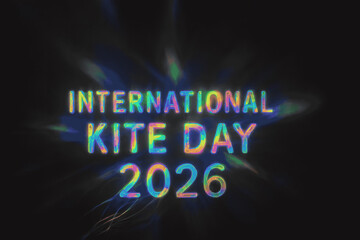 A holographic diffraction grating. When light hits it, the only visible thing is the shimmering, rainbow-spectrum text International Kite Day 2026, which appears to float in mid-air