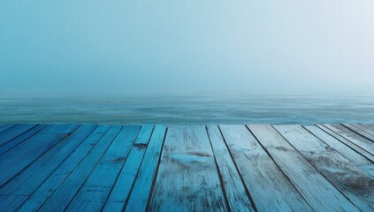 Weathered wooden planks in cool tones lead to hazy ocean and sky