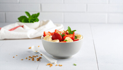 A bowl of strawberry and banana muesli with yogurt presented as a healthy morning meal, highlighting natural fruits