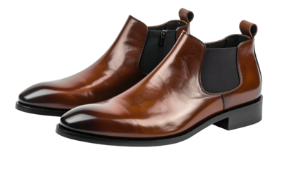 A pair of polished, leather ankle boots displayed against a black background. One is slightly behind the other. The boots feature an elastic side panel and a smooth finish