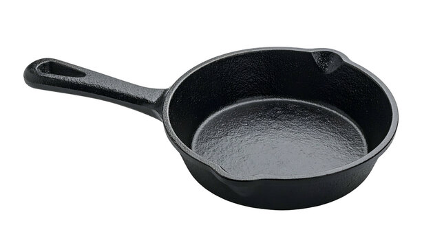 Black, cast-iron skillet, isolated on a stark, black background. Angled view showcases the pan's handle, pouring lip, and textured interior
