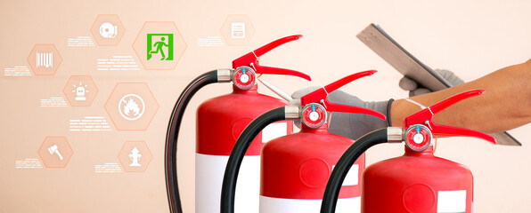 Firefighters are checking red fire extinguisher tank for protection and prevent and safety rescue...