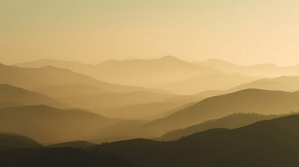 Golden hazy mountain layers at sunrise with soft light