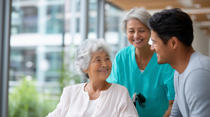 A high-resolution professional stock photograph of an Asian elderly woman greeting caregivers in a care facility, warm and positive senior care scene focused on communication, resp