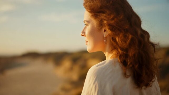 Serene woman with curly hair enjoying a beach sunset, perfect for lifestyle and travel themes