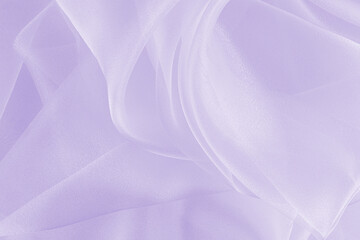 Large soft waves of white organza on a delicate lilac or purple background. the texture of silk fabric. layout for design. A copy of the space.