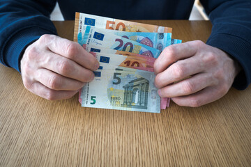 European currency in a man's hands.
