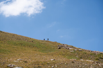 High-altitude mountain pass in the Trans-Ili Alatau range. Gravel road among Tuyuk-Su glaciers and rocky valleys, Tien Shan, Central Asia