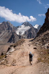 High-altitude mountain pass in the Trans-Ili Alatau range. Gravel road among Tuyuk-Su glaciers and rocky valleys, Tien Shan, Central Asia