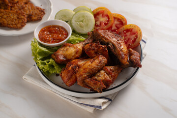 Ayam Goreng Lengkuas Kremes or Galangal Fried Chicken, One of Indonesia's culinary icons. Perfect for recipes, articles or any cooking content.