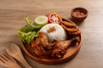 Indonesian Ayam Goreng Fried Chicken with Rice, Sambal, and Fresh Salad. Perfect for recipes, articles or any cooking content.