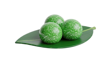 Three green speckled balls on a banana leaf