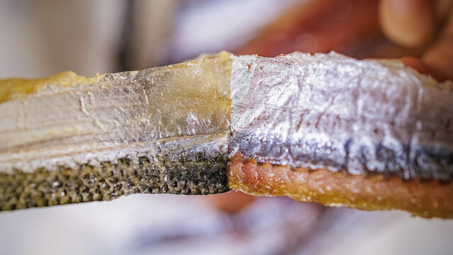 Traditional Korean Gwamegi Preparation: peeling silver skin off dried saury