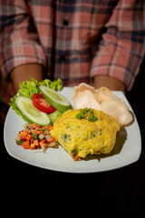 Delicious Omelette Meal with Fresh Salad, Vegetables, and Crispy Crackers Served by Hand