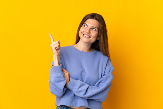 Young Slovak woman isolated on yellow background pointing up a great idea