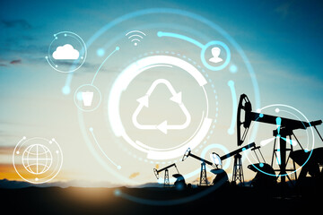 Oil pump jacks silhouette with digital recycling and technology icons overlay on sunset background expressing energy transition concept.
