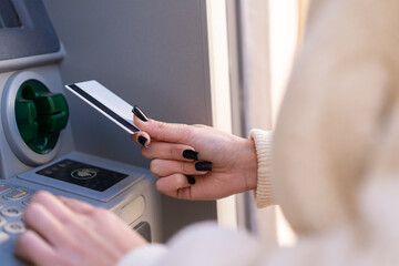 Young moroccan girl  at outdoors using an ATM