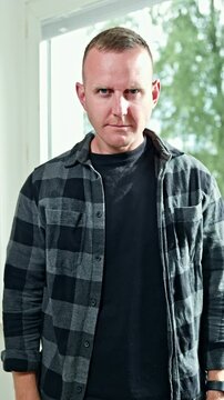 Emotional grimaces on a man's face close-up. A man looks grimly into the camera. A man's face with an angry expression on it. A man looks disdainfully in front of him.